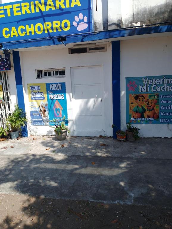 a building with a white door and signs on it at Rinconcito Veracruzano in Veracruz
