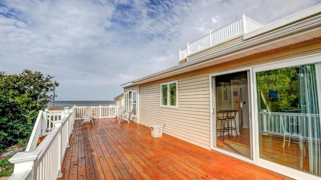 a house with a deck with a view of the ocean at Sunset Retreat in North Cape May