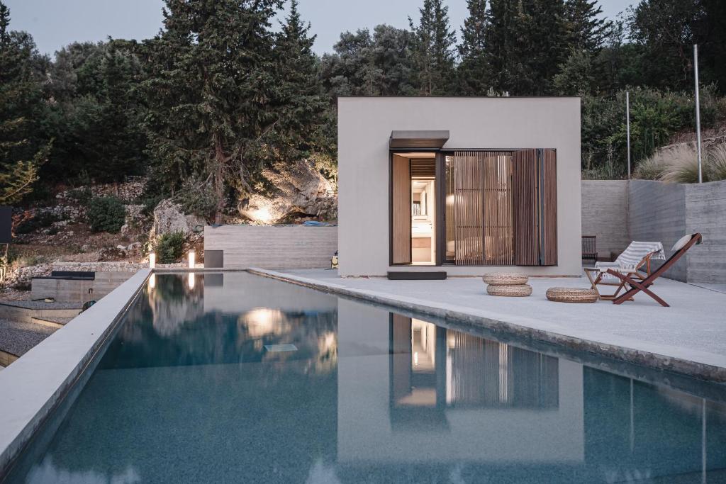 a house with a swimming pool next to a house at Ukino House in Nikiana