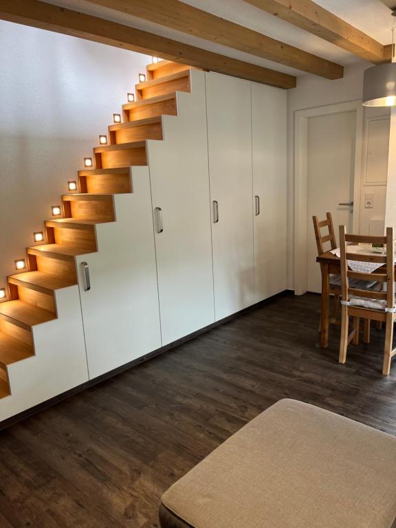 a staircase in a room with a table and chairs at Tinywohnung in Schluchsee