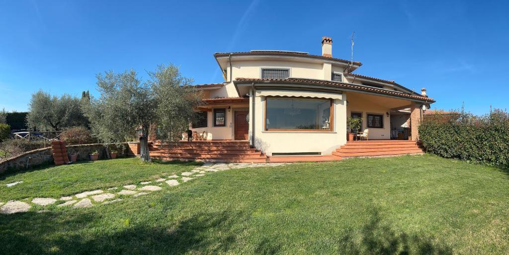 a large house with a large lawn in front of it at Linda's Retreat in Fiano Romano