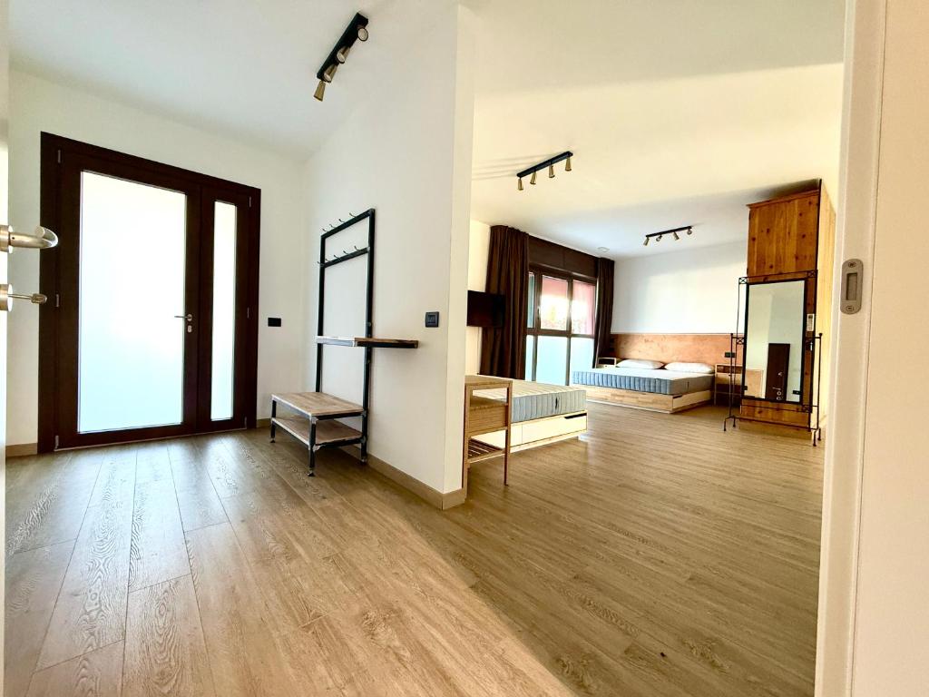 a large room with wooden floors and white walls at INCLUSIVeLOFT in Legnano