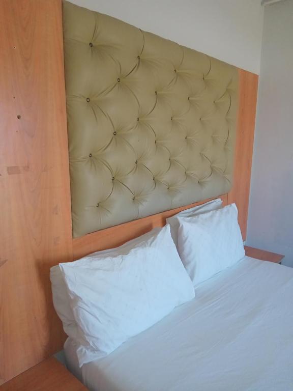 a bed with two white pillows in a room at Star Legend lodge in Parow