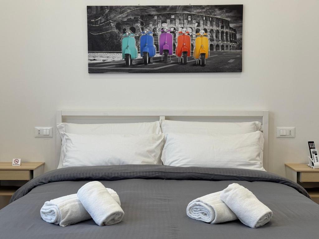a bedroom with a bed with two towels on it at OTB ITALIA - Airport Rooms in Treviso