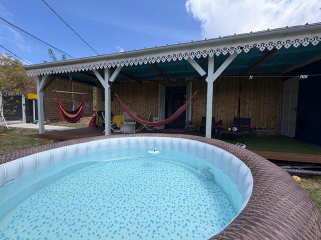 a large swimming pool in front of a house at Kaz a Ma-Lu in Le Marin