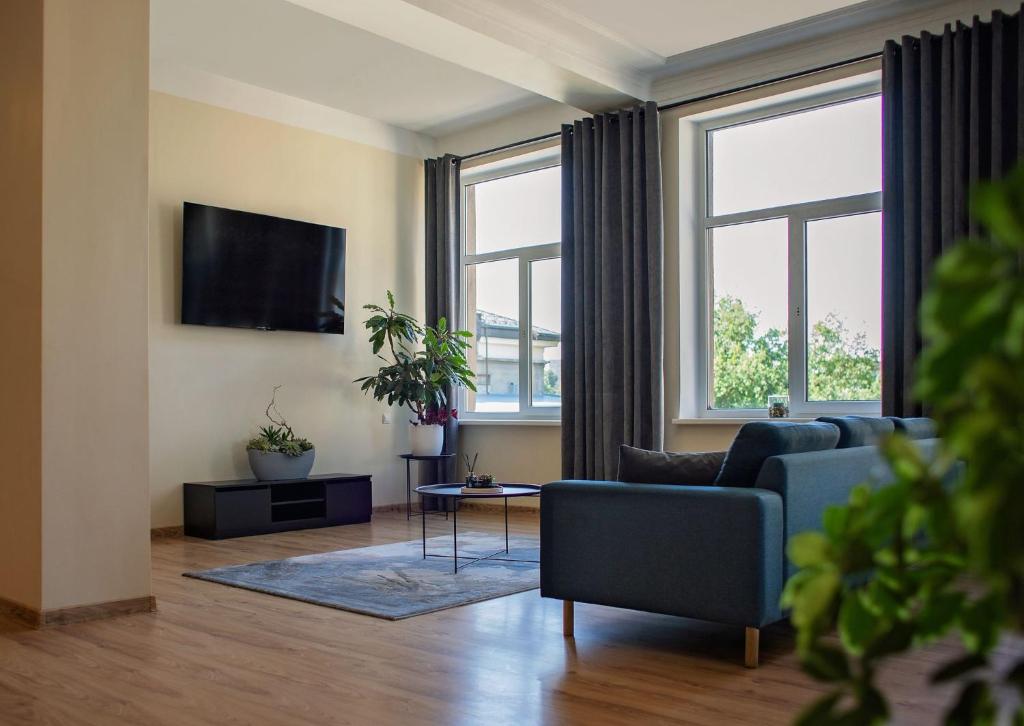 a living room with a couch and a tv at Stoties Hostelis in Vilnius