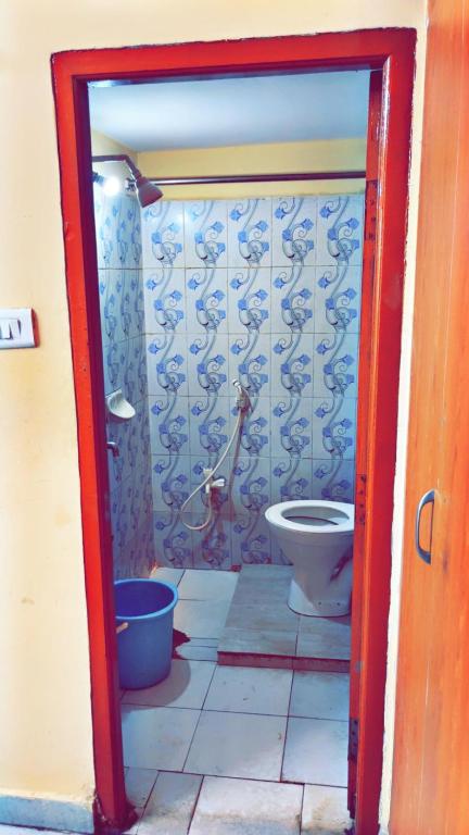 a bathroom with a toilet in a room at Pavani staycation in Medchal