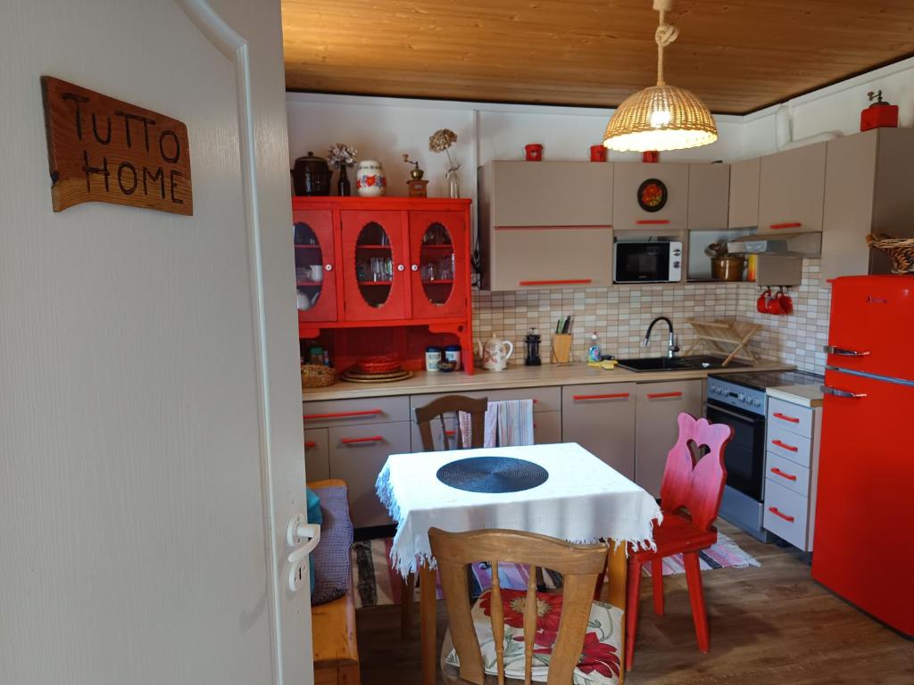 a kitchen with a table and a red refrigerator at TUTTO Home in Frýdlant nad Ostravicí