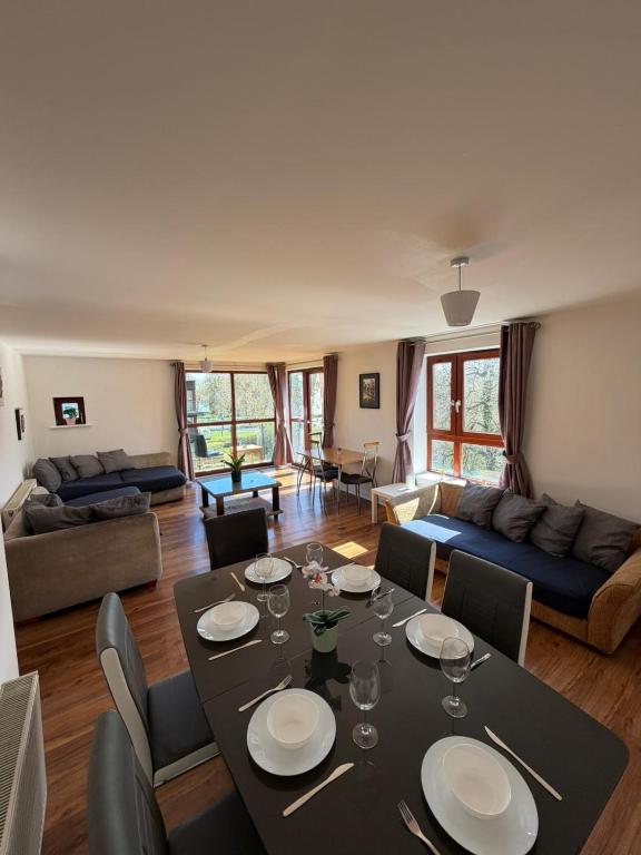 a living room with a table and a couch at Superb 3-Bed Residence Airport in Dublin