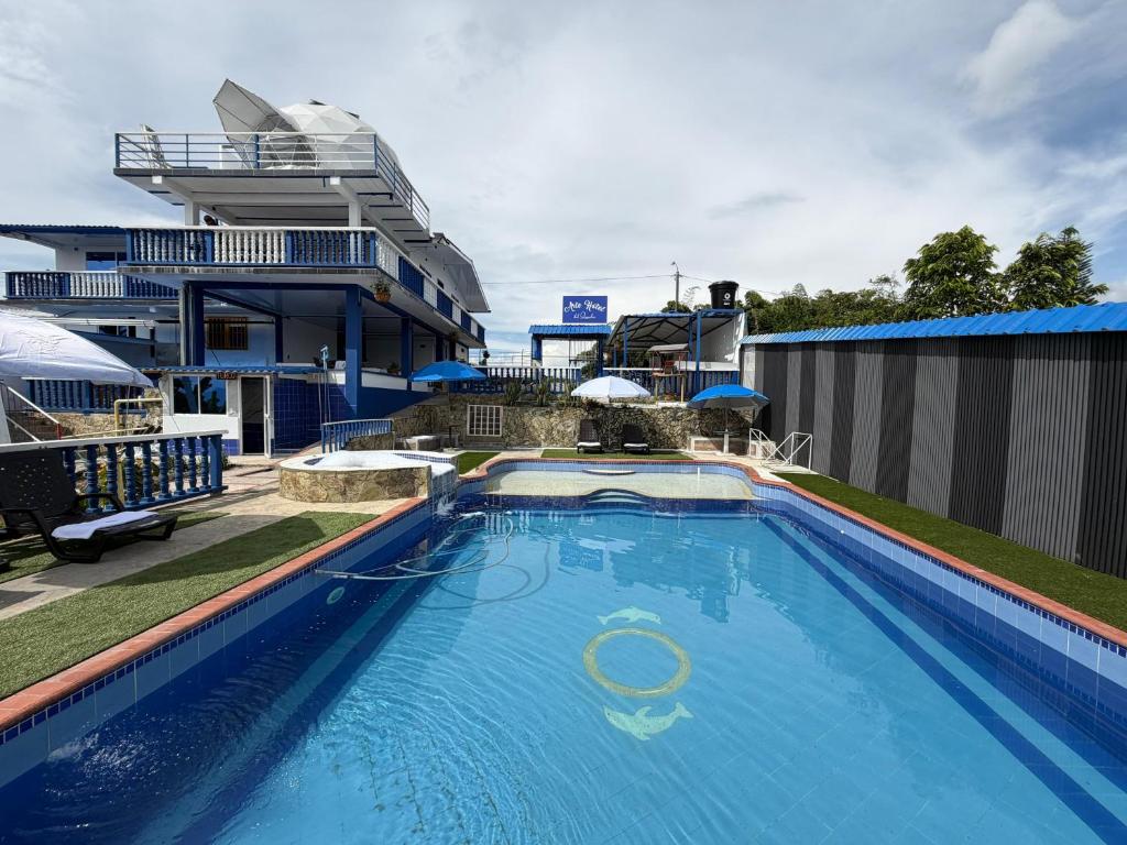 a large swimming pool in front of a building at Arte Hotel del Quindío in Filandia
