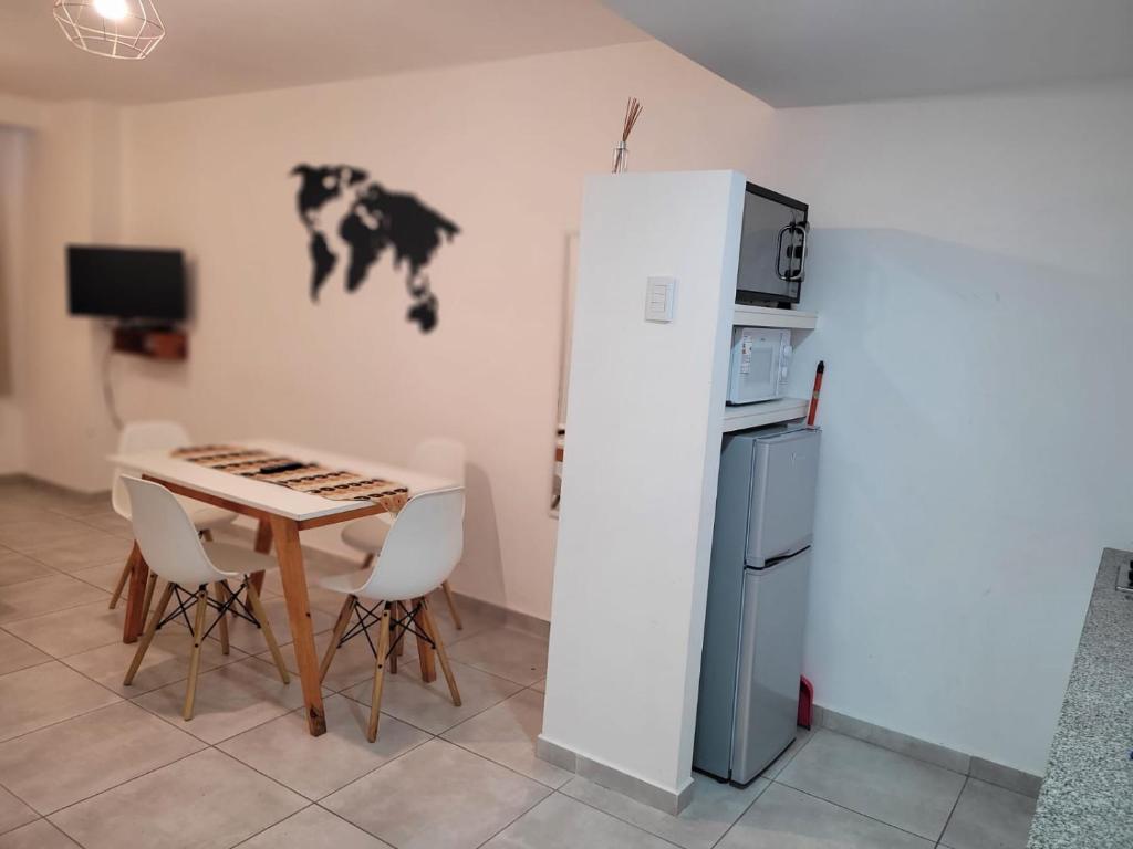a small kitchen with a table and a refrigerator at Depto Temporario La Plata in La Plata