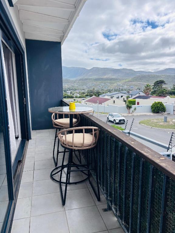 a balcony with a table and chairs and a view at Capri Horizon Hideaway in Fish Hoek