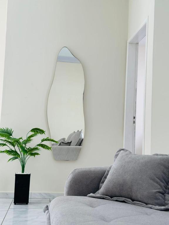 a living room with a couch and a mirror on the wall at Casa da Lua in Barreirinhas