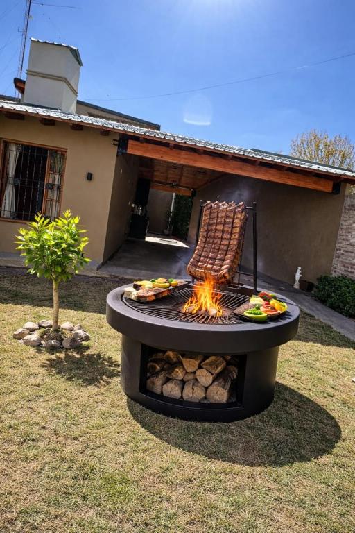 a fire pit in a yard with a chair on it at Refugio Andino in Tupungato