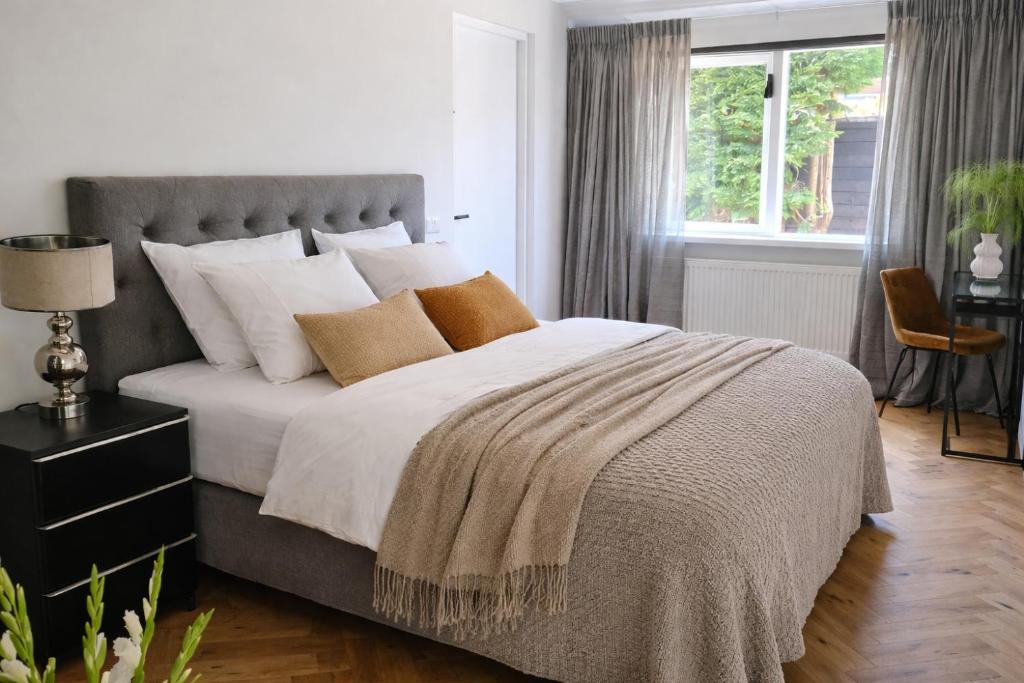 a bedroom with a large bed with white sheets and pillows at Bergen Delight in Bergen