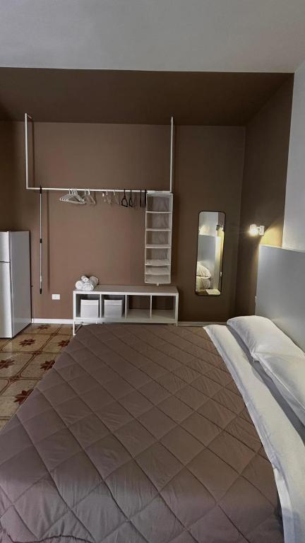 a bedroom with a large bed and a table at CORFÙ 19 Bed & Breakfast in Schiavonea