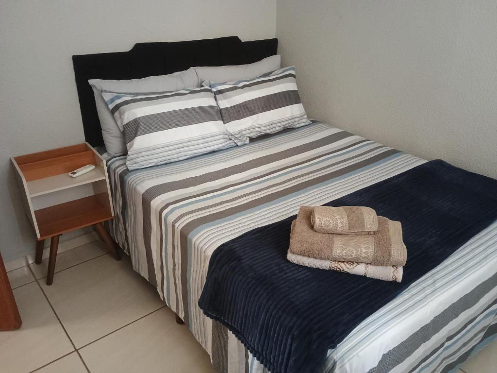 a bed with a pillow and a towel on it at La Bella casa in Catanduva