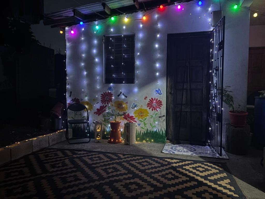 a room with a door with lights on it at Riddim Vybz guesthouse in Kingston