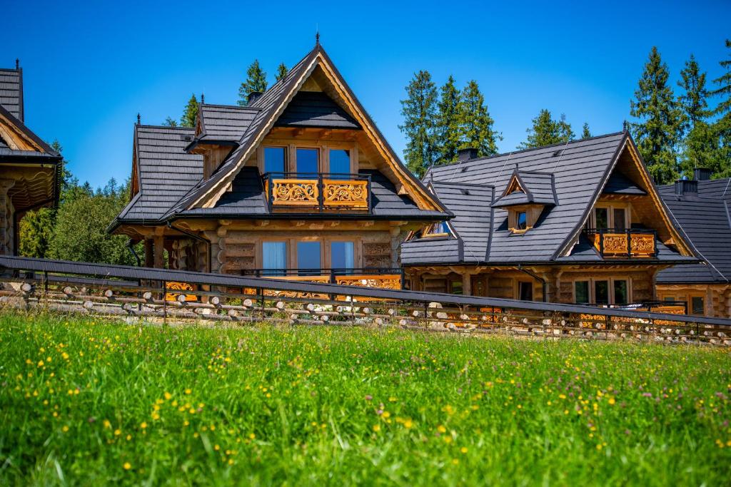 a large wooden house with a roof at Domki Tatra Loft in Ząb