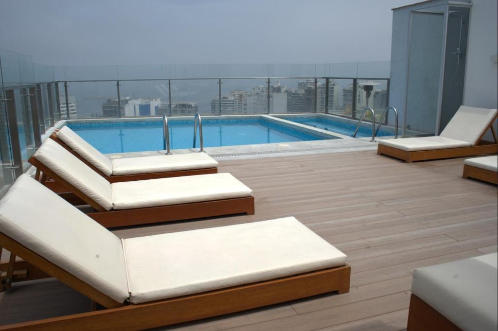 a balcony with a swimming pool on a building at Inca inn apartments in Lima