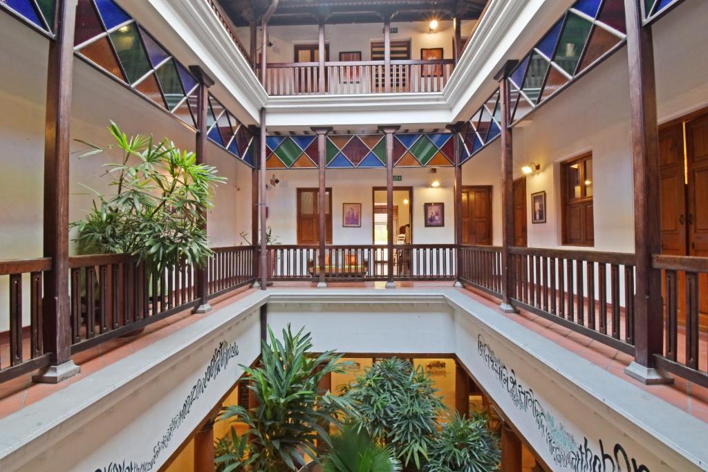 an indoor pool in a building with stained glass windows at Maison Perumal Pondicherry - A CGH Earth Experience in Pondicherry