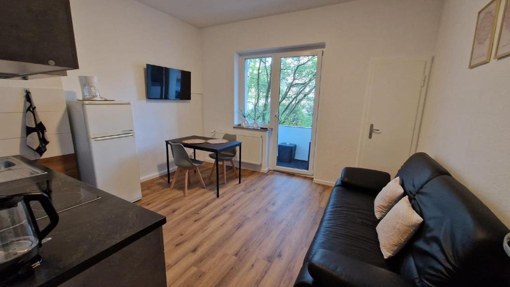 a living room with a couch and a table at Viktoria's Appartment 2 in OB-Mitte in Oberhausen