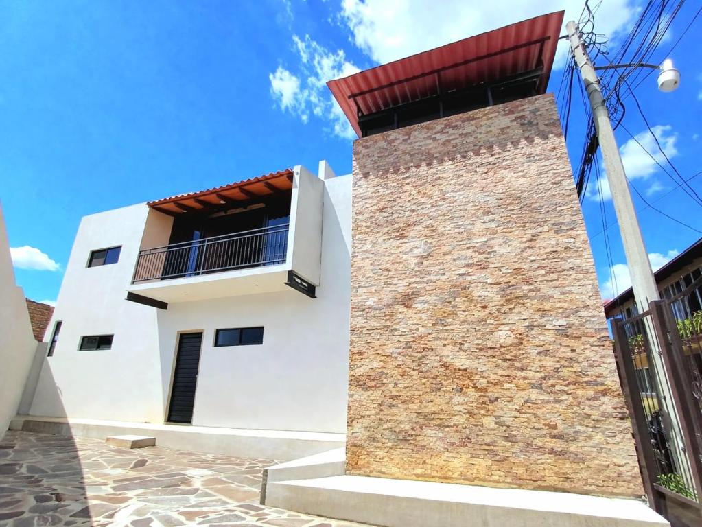 a white house with a red roof at Casa Luca in Mazamitla
