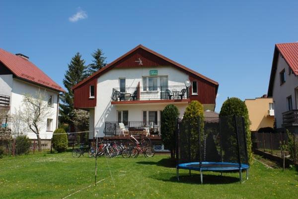a house with a blue trampoline in the yard at Anmar Pokoje Narty Rowery in Stronie Śląskie