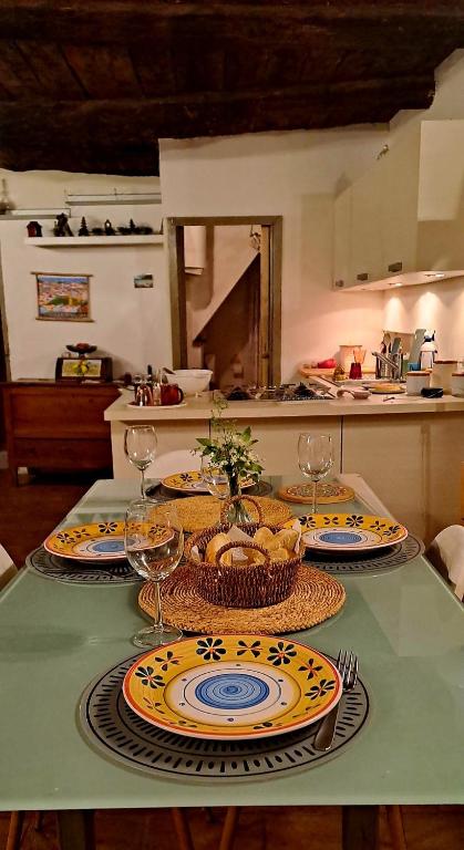 a table with plates of food on it in a kitchen at Casa Odara suite centro storico in Calcata