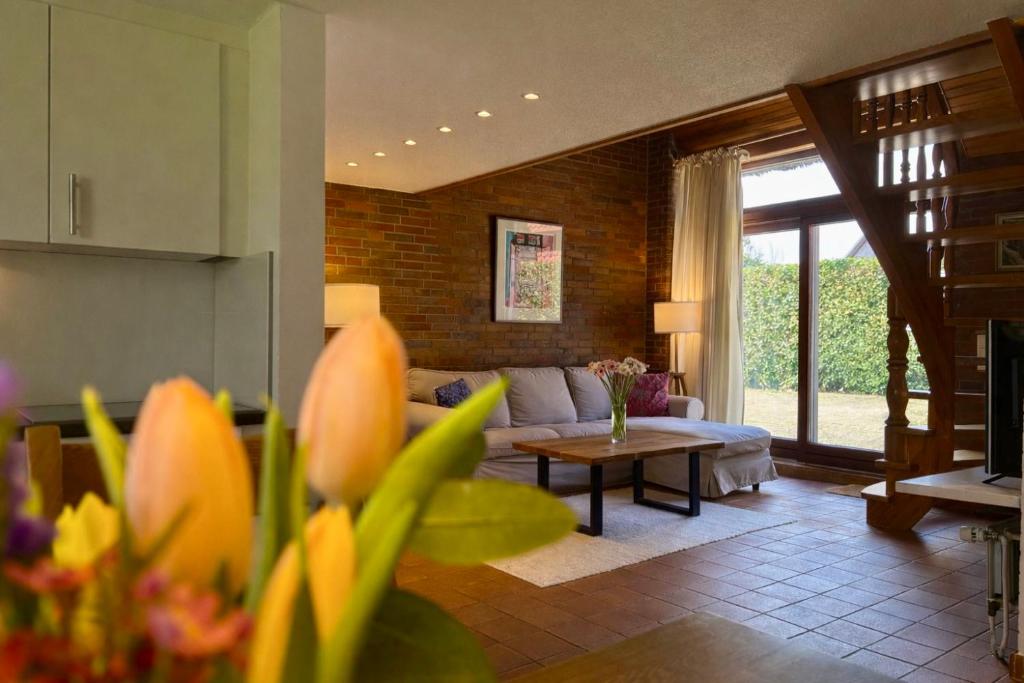 a living room with a couch and a table at Altes Friesenhaus Scheune in Morsum
