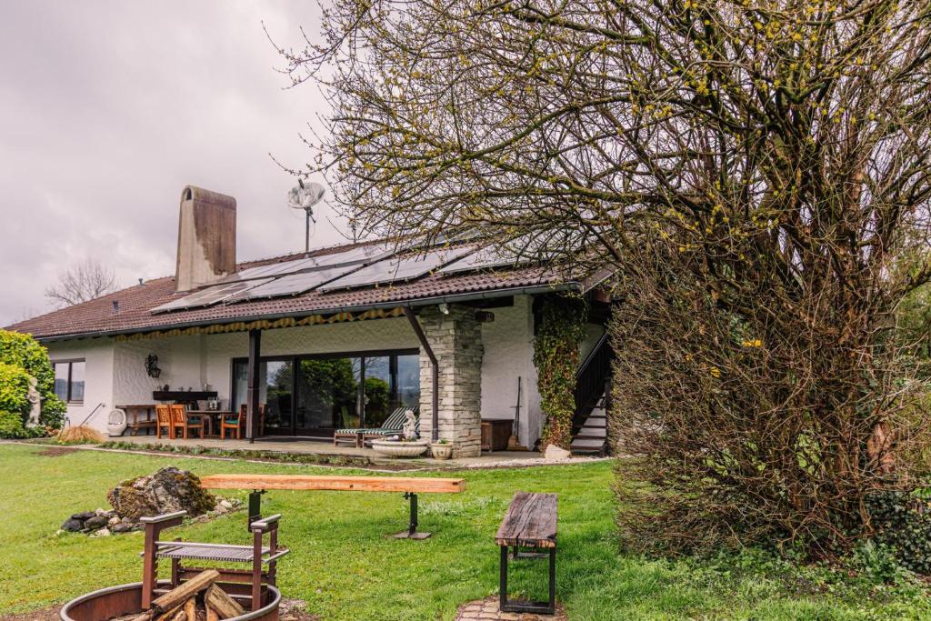a house with a picnic table in the yard at Landhausvilla Watzmannblick in Saaldorf-Surheim
