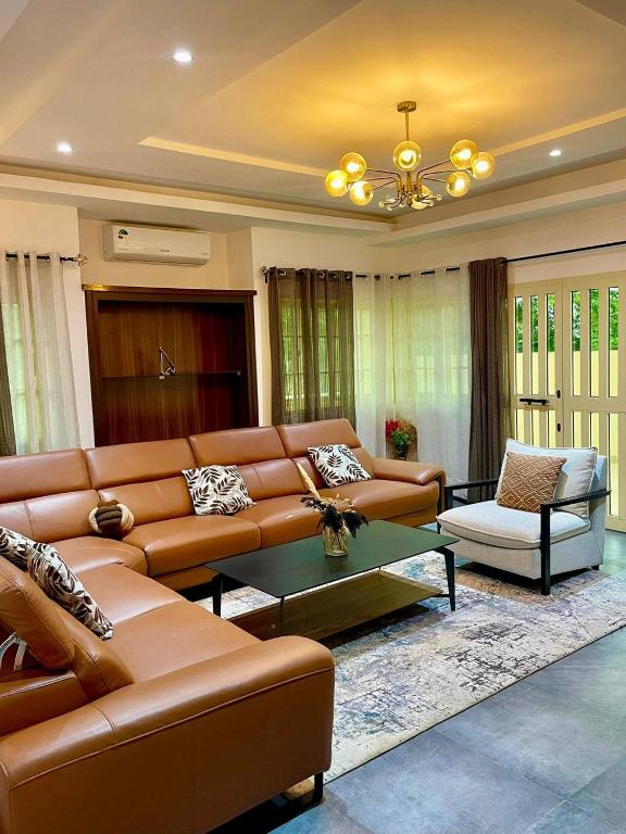 a living room with a couch and a coffee table at Residence EBENE in Kika