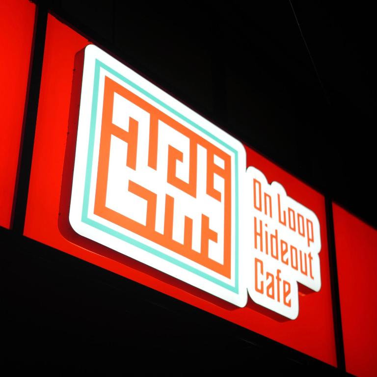 a sign for a fast food restaurant with red and white at Aostel in Chennai