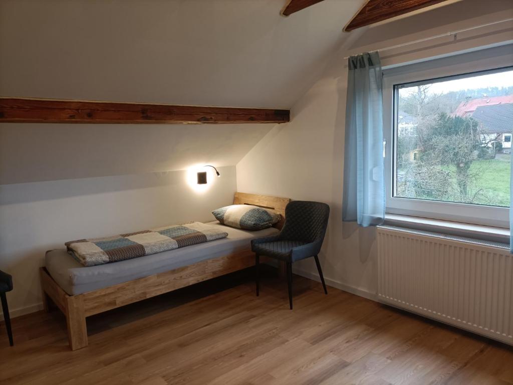 a small bedroom with a bed and a window at Gästezimmer Kalletal in Kalletal