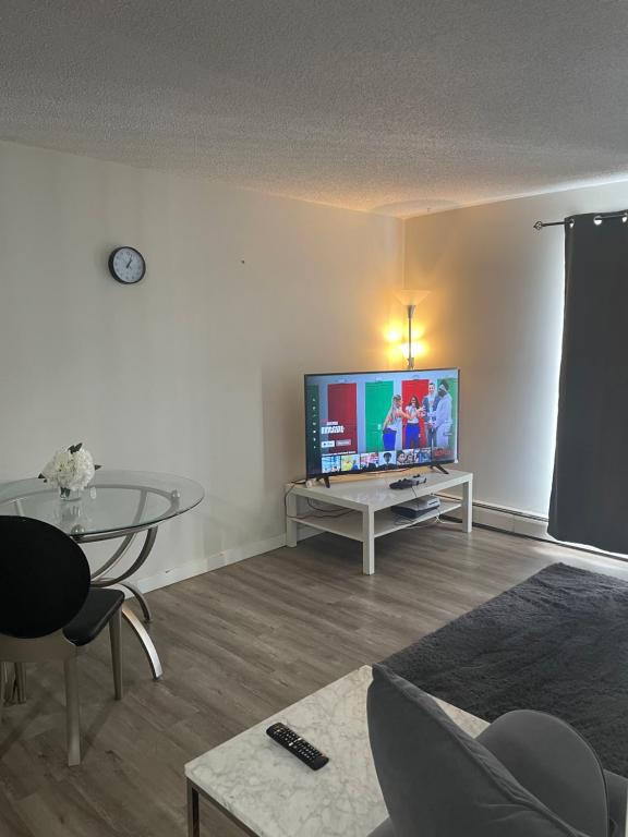 a living room with a large flat screen tv at Ron's Place in Saskatoon