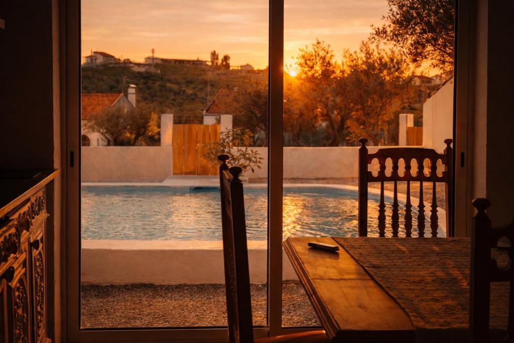 a view of a swimming pool from a door at Cantinho do frade in Alandroal
