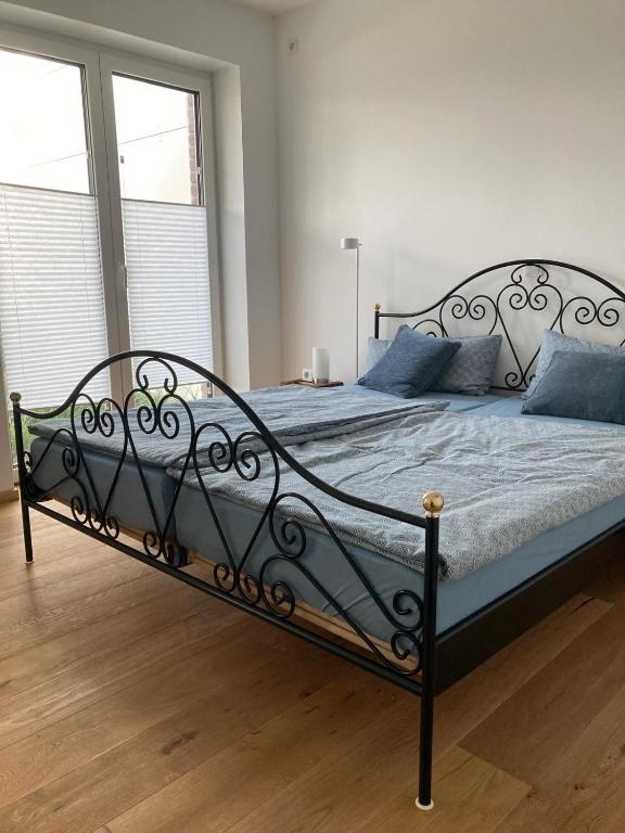 a bedroom with a bed with blue pillows at Ferienwohnung Strandmuschel in Lembruch