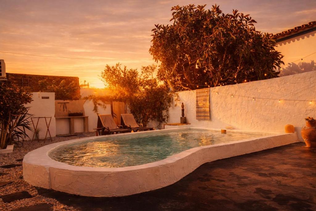 a swimming pool in a yard next to a building at Refúgio do Frade in Aldeia do Mato