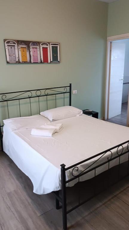 a large bed in a bedroom with a white bedspread at HOTEL Via Emilia Ovest 224 SELF CHECK-IN in Parma