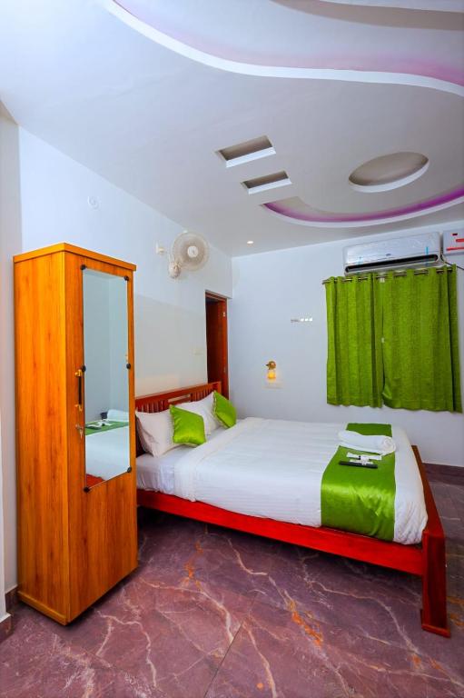 a bedroom with two beds and a mirror at Fairy Beach House - DK Resort in Pondicherry