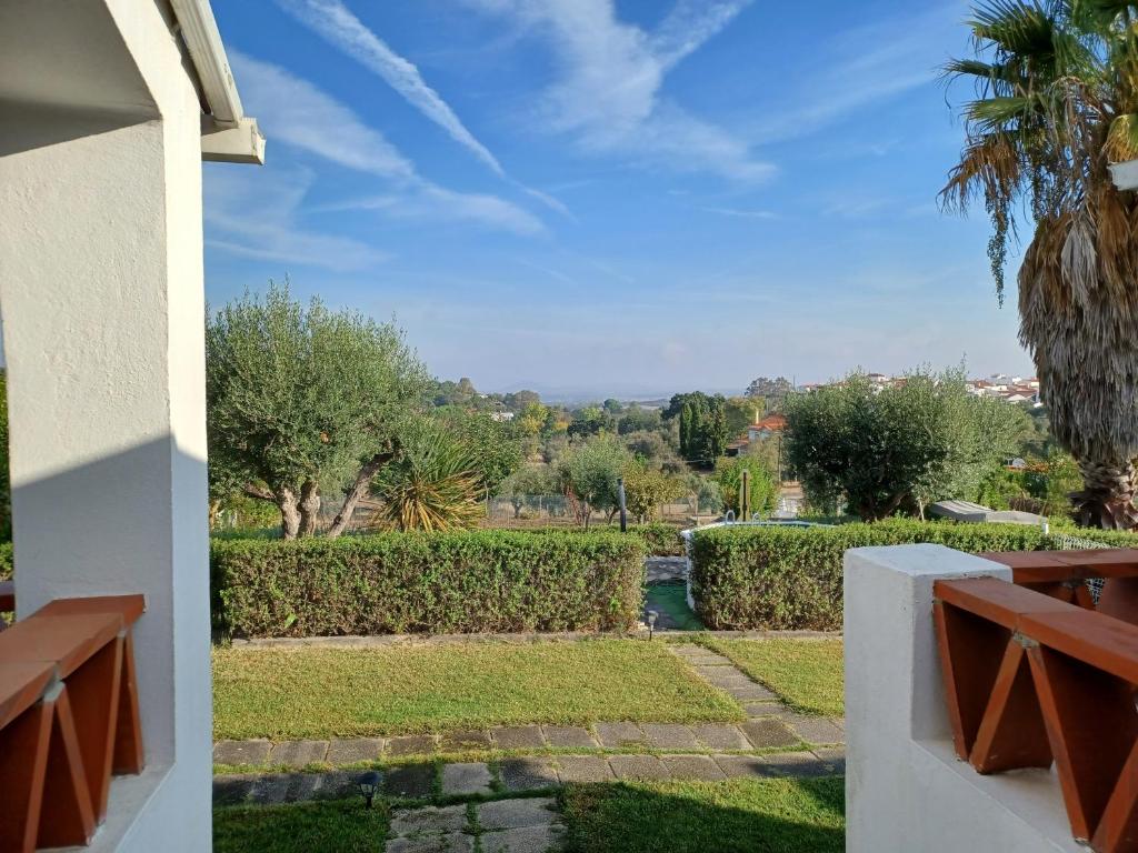 a view of a garden from the balcony of a house at Casa das 3 Palmeiras in Arraiolos