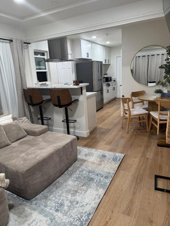 a living room and kitchen with a couch and a table at Chic East LA Retreat 2 bedroom-sleeps 6-Near DTLA-Car Rental Service on Property in East Los Angeles