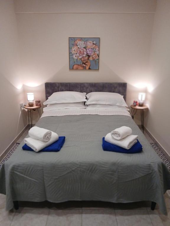a bedroom with a large bed with towels on it at Ioana Sea View in Corfu