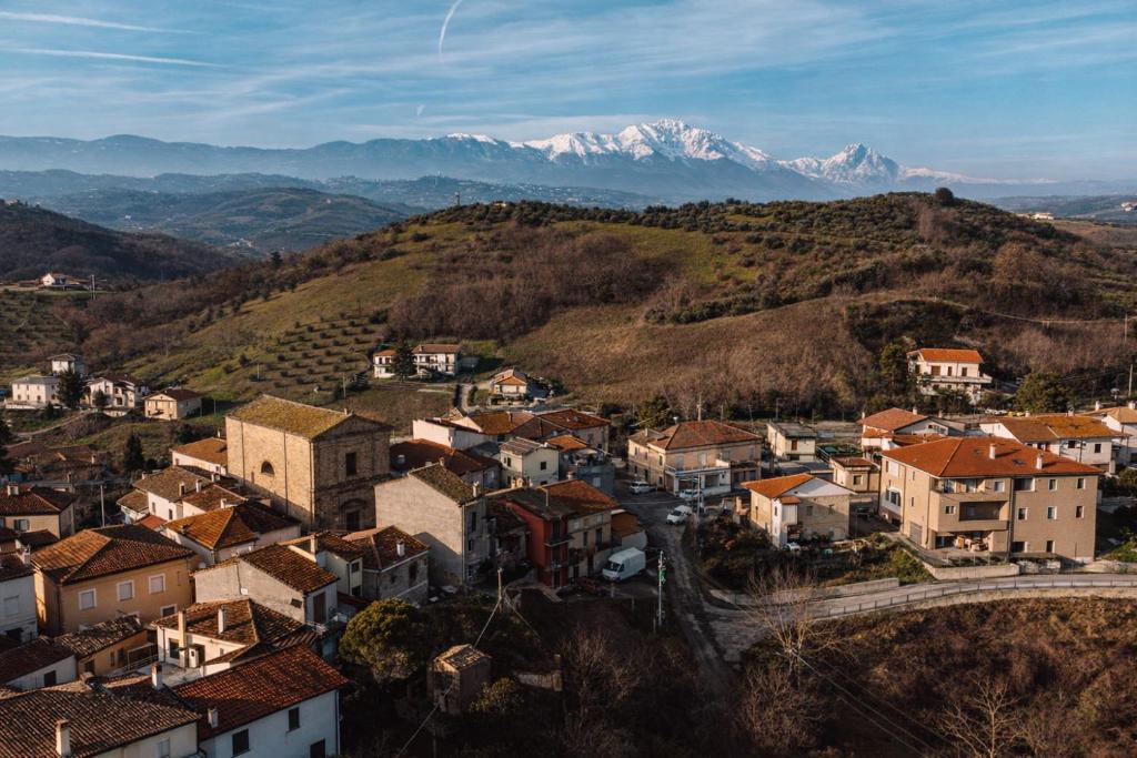 a town on a hill with mountains in the background at La Casetta - un piccolo angolo di pace in Piccianello