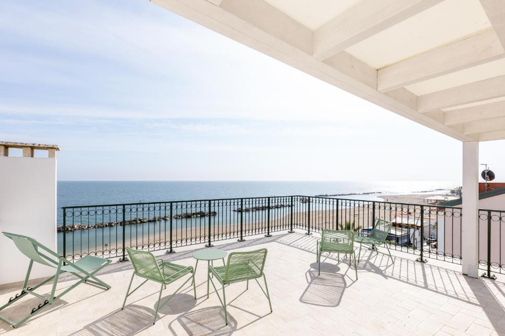 a balcony with chairs and a view of the ocean at Affittacamere 2 Prima Fila Mare in Porto Recanati