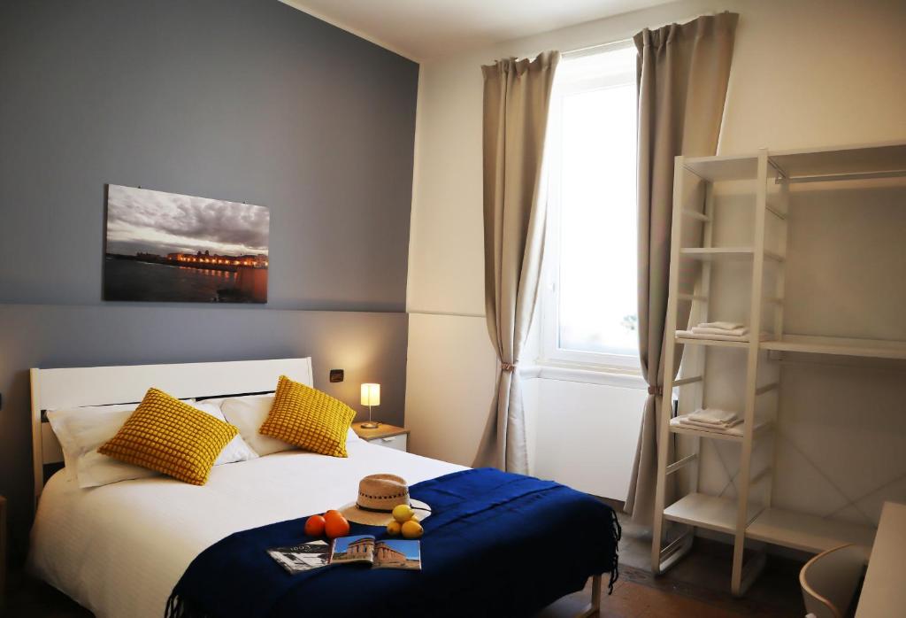a bedroom with a bed with a teddy bear sitting on it at Fortuna Guest House - Charm & Relax rooms in Syracuse