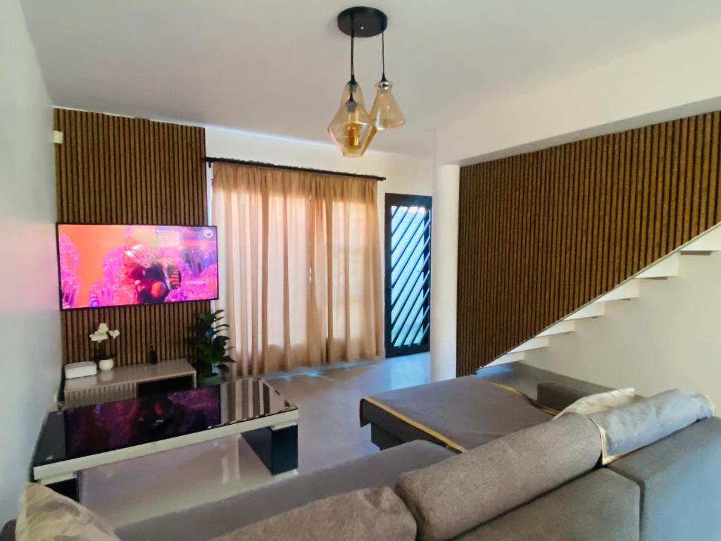 a living room with a couch and a tv at Lagoon Staycation in Walvis Bay