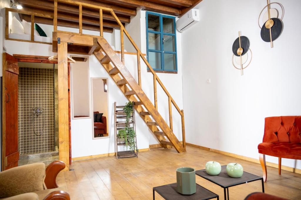 a living room with a wooden staircase in a house at Old Town Nest in Rhodes Town