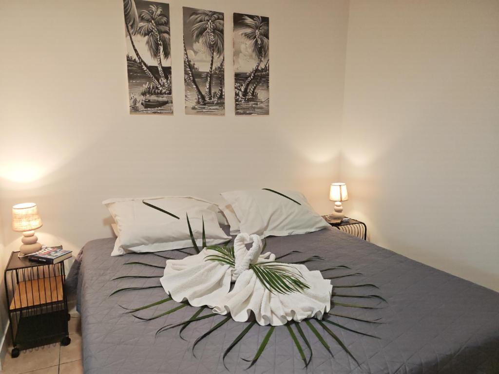 a bedroom with a bed with two pictures on the wall at Enjoy Studio in Pointe-Noire