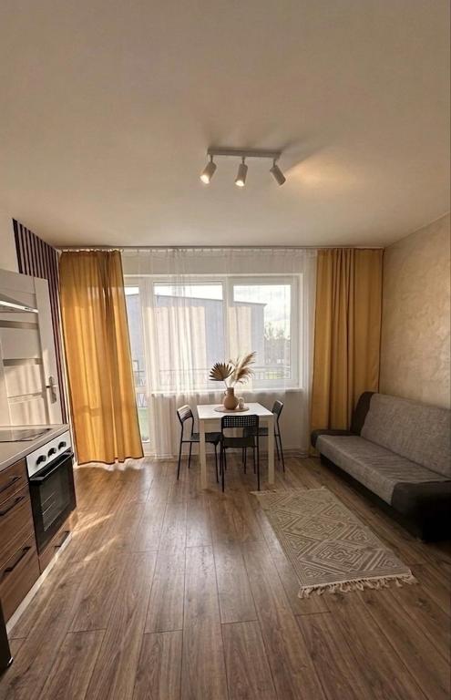 a living room with a table and a couch at Apartamenty W Domu in Białystok